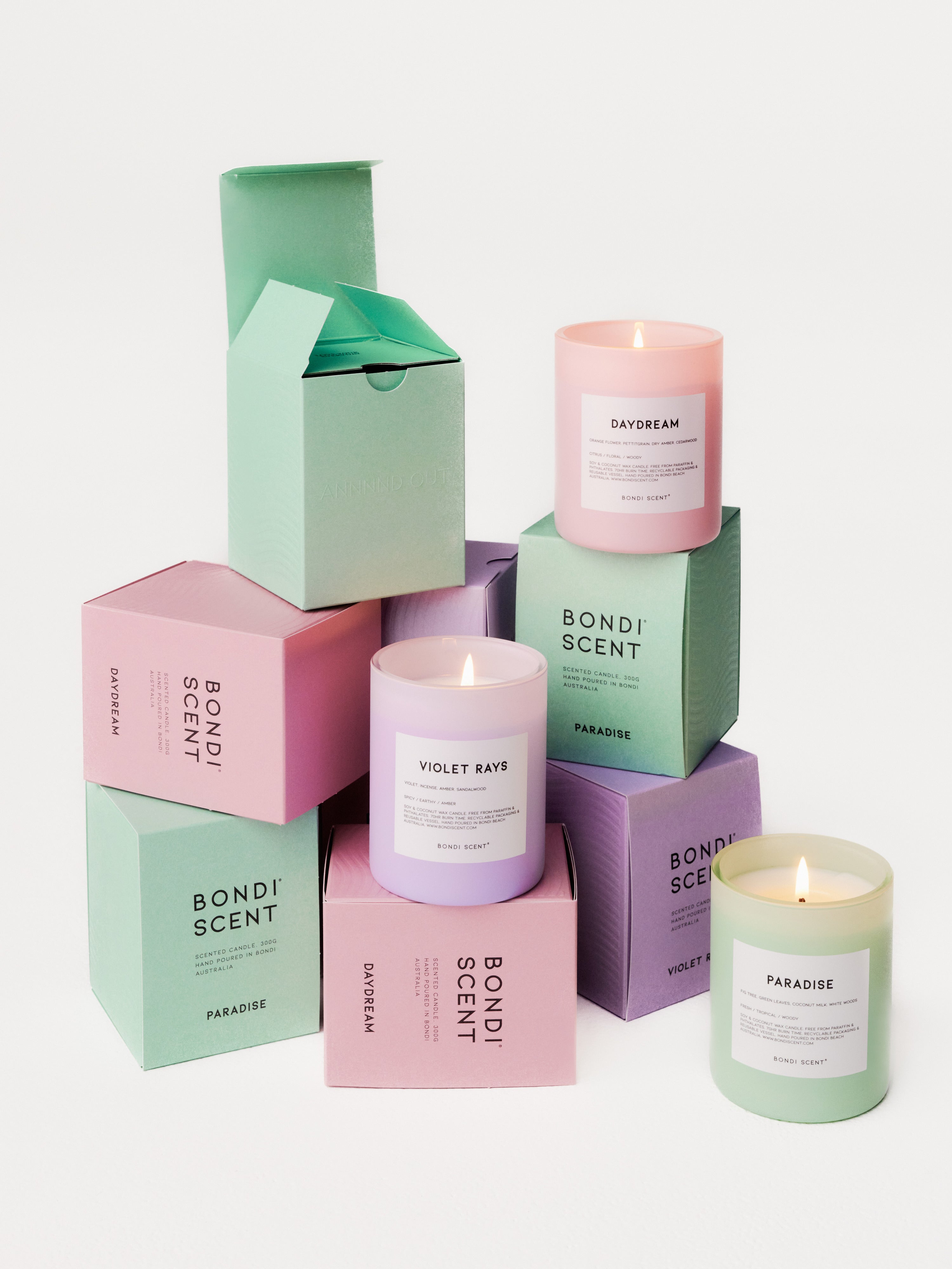 Collection of stacked Bondi Scent 'Dopamine Trio' scented candles on white background.