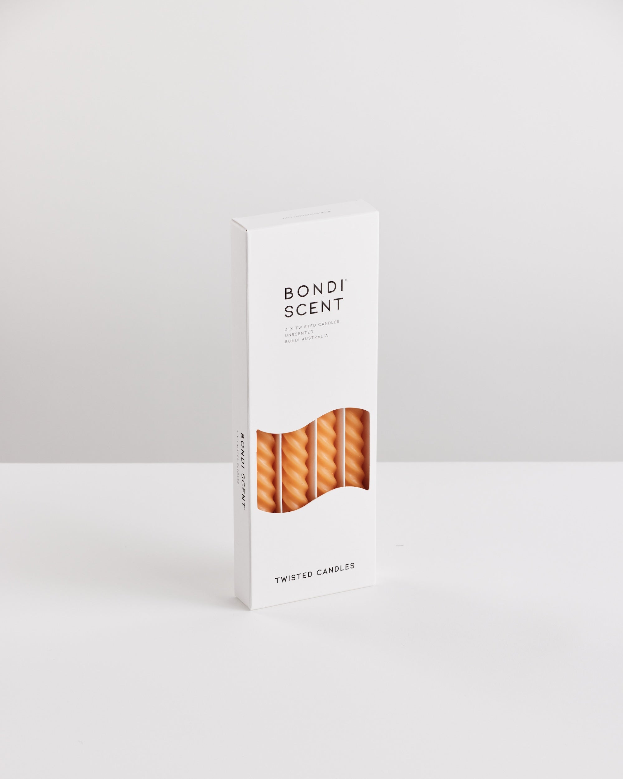 Bondi Scent orange twisted dinner candles in white packaging box on white background