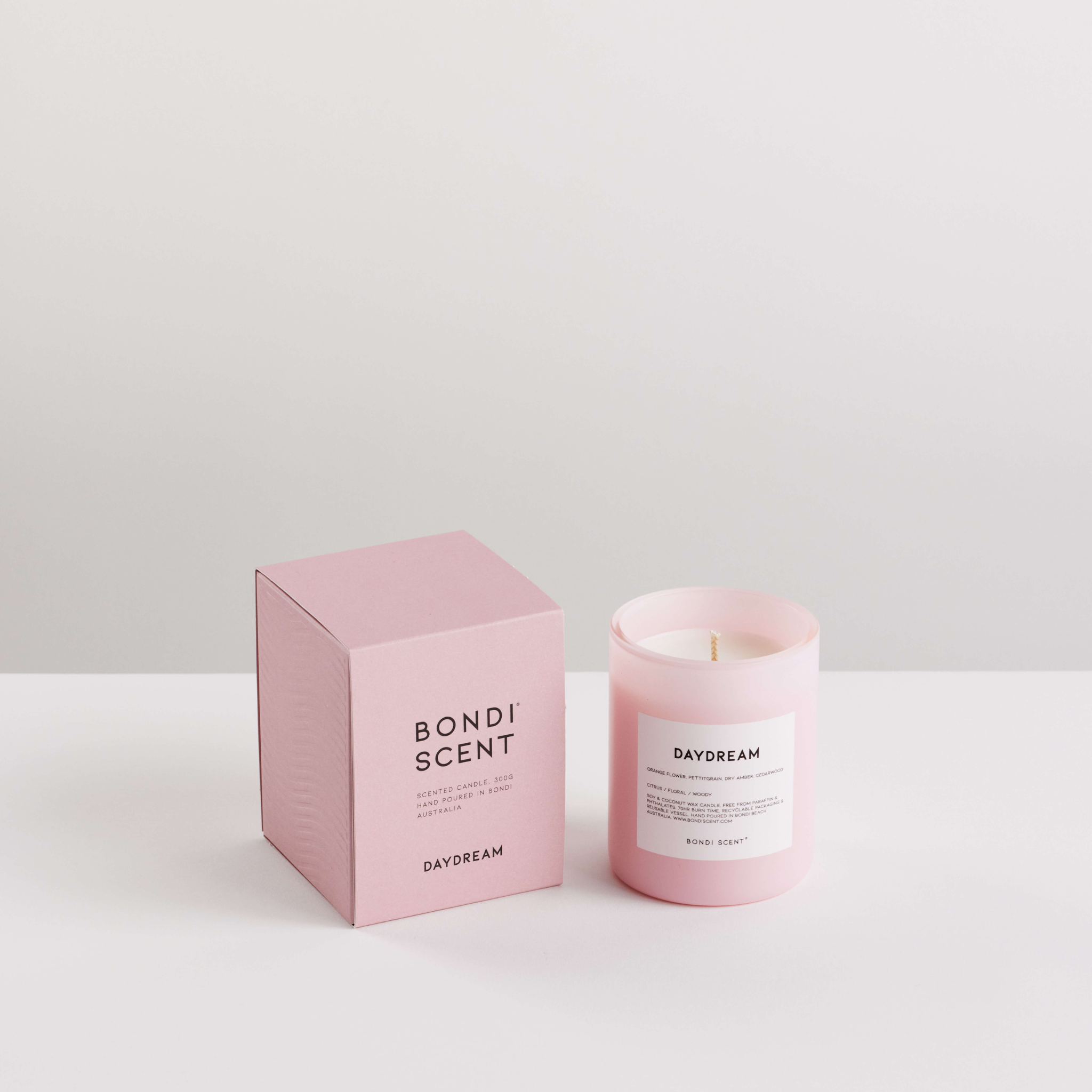 Pink candle and packaging with &