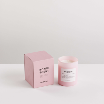 Pink candle and packaging with &