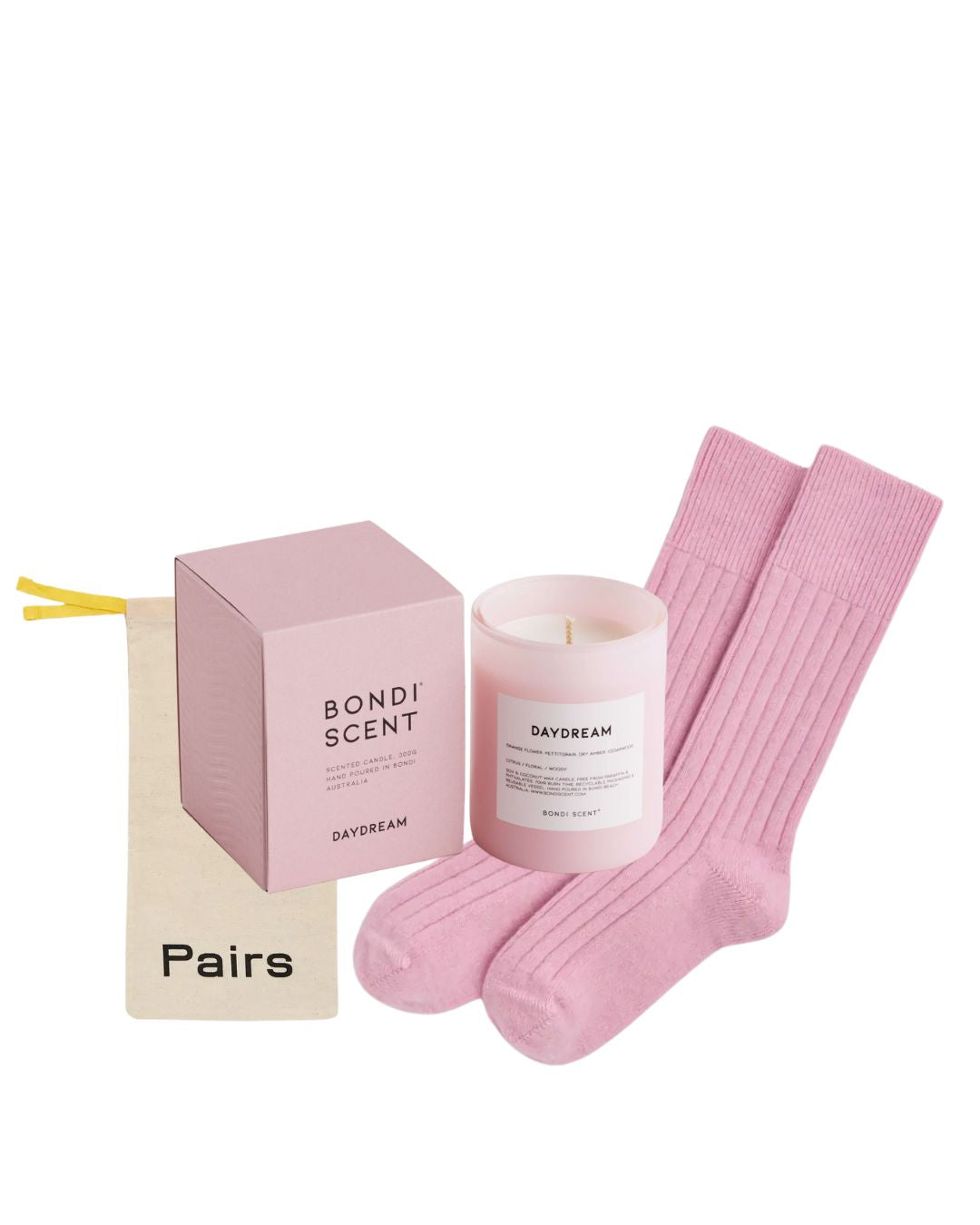 Pink candle, pink socks, and pink packaging on a white background