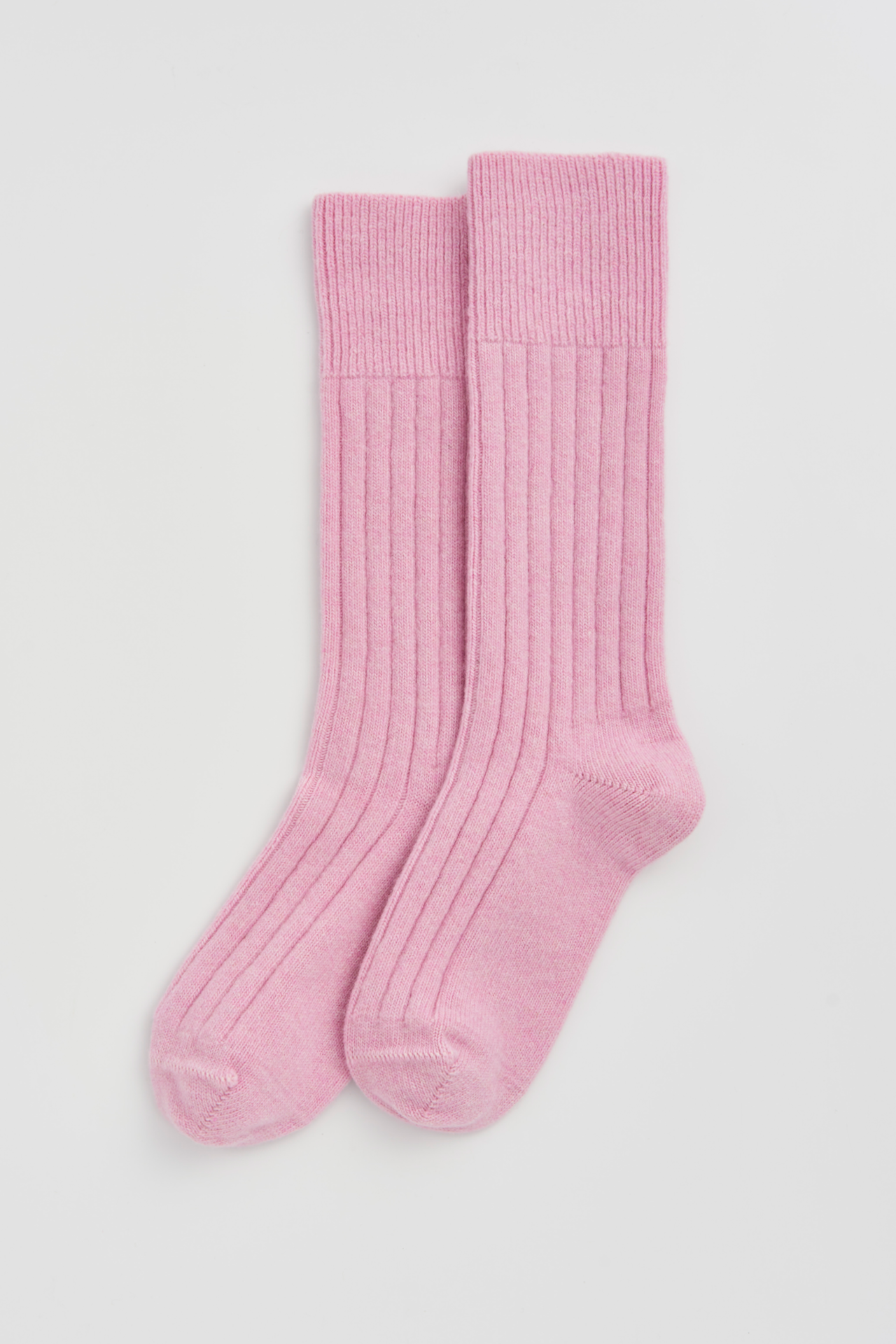 Pair of pink socks on a light gray background