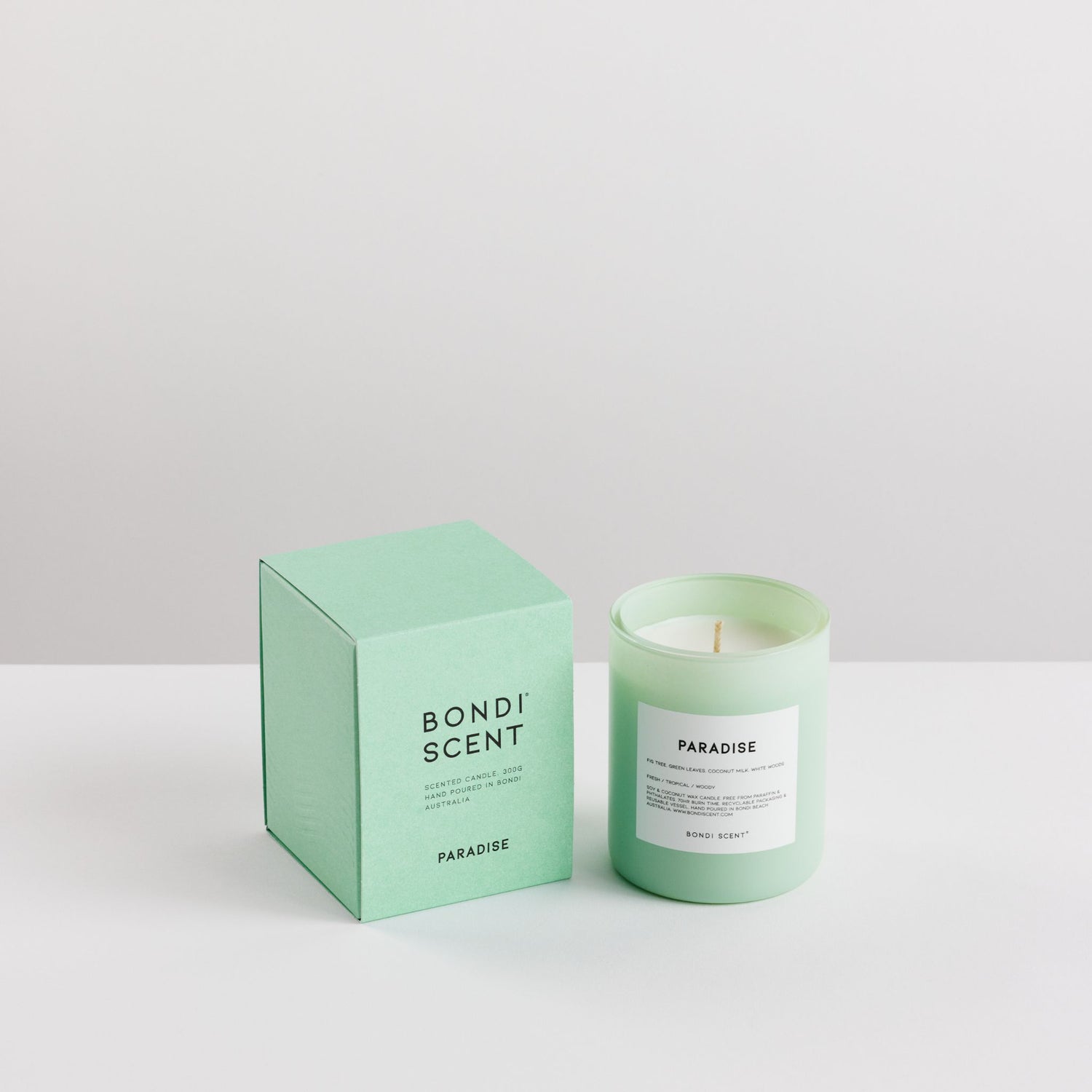 Green candle and packaging with &