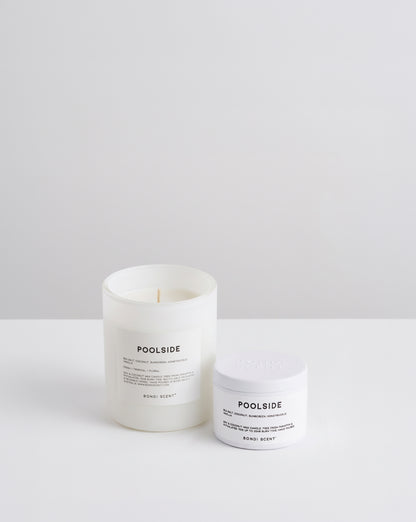 A white glass jar candle and a white plastic jar cream from the brand POOLSIDE, both labeled &