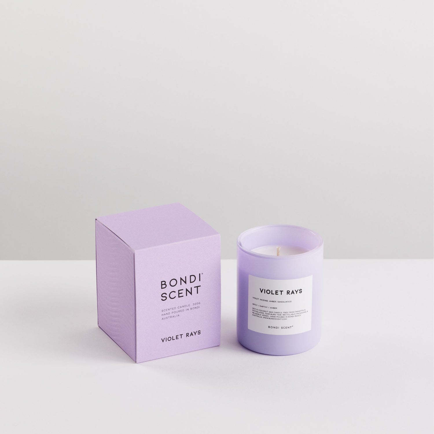 Purple candle and packaging with &