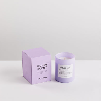 Purple candle and packaging with &