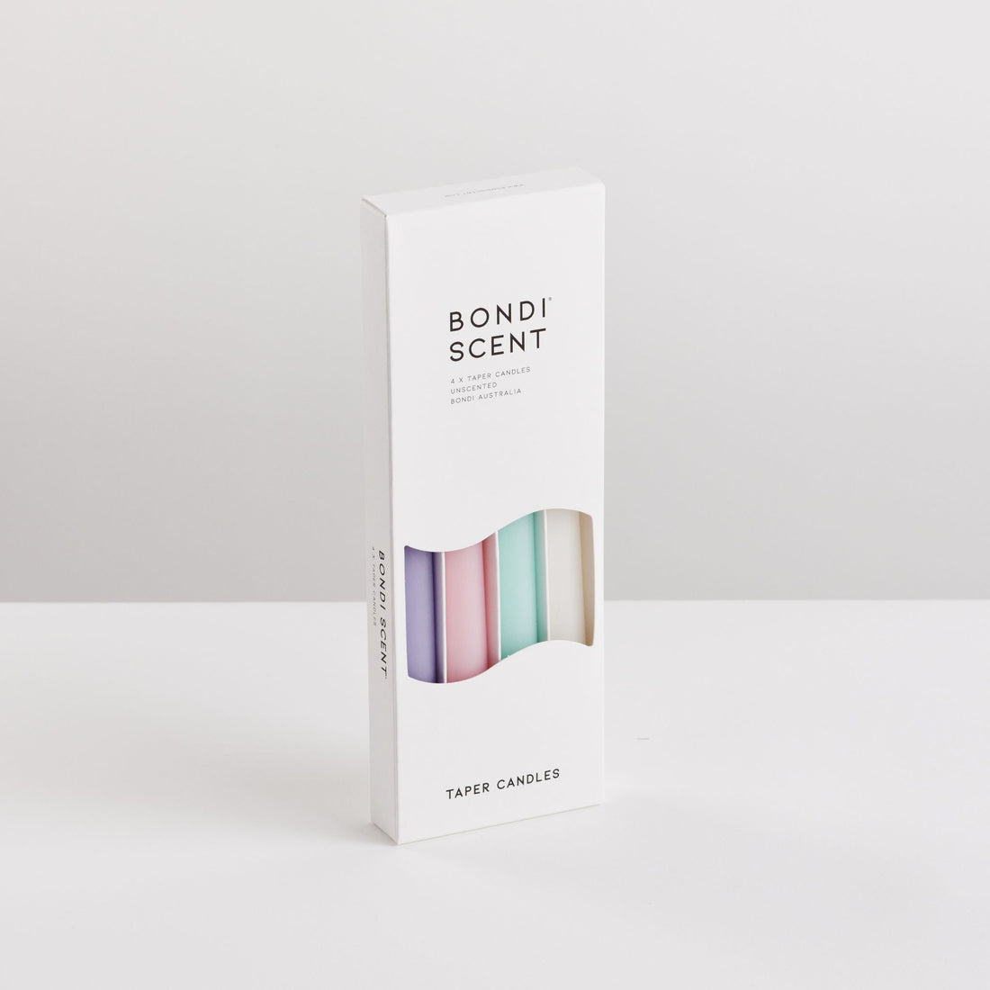 Bondi Scent multi colour taper candles in packaging box on white background