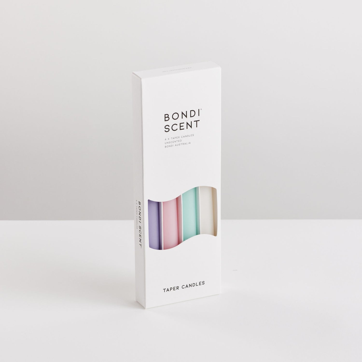 Bondi Scent multi colour taper candles in packaging box on white background