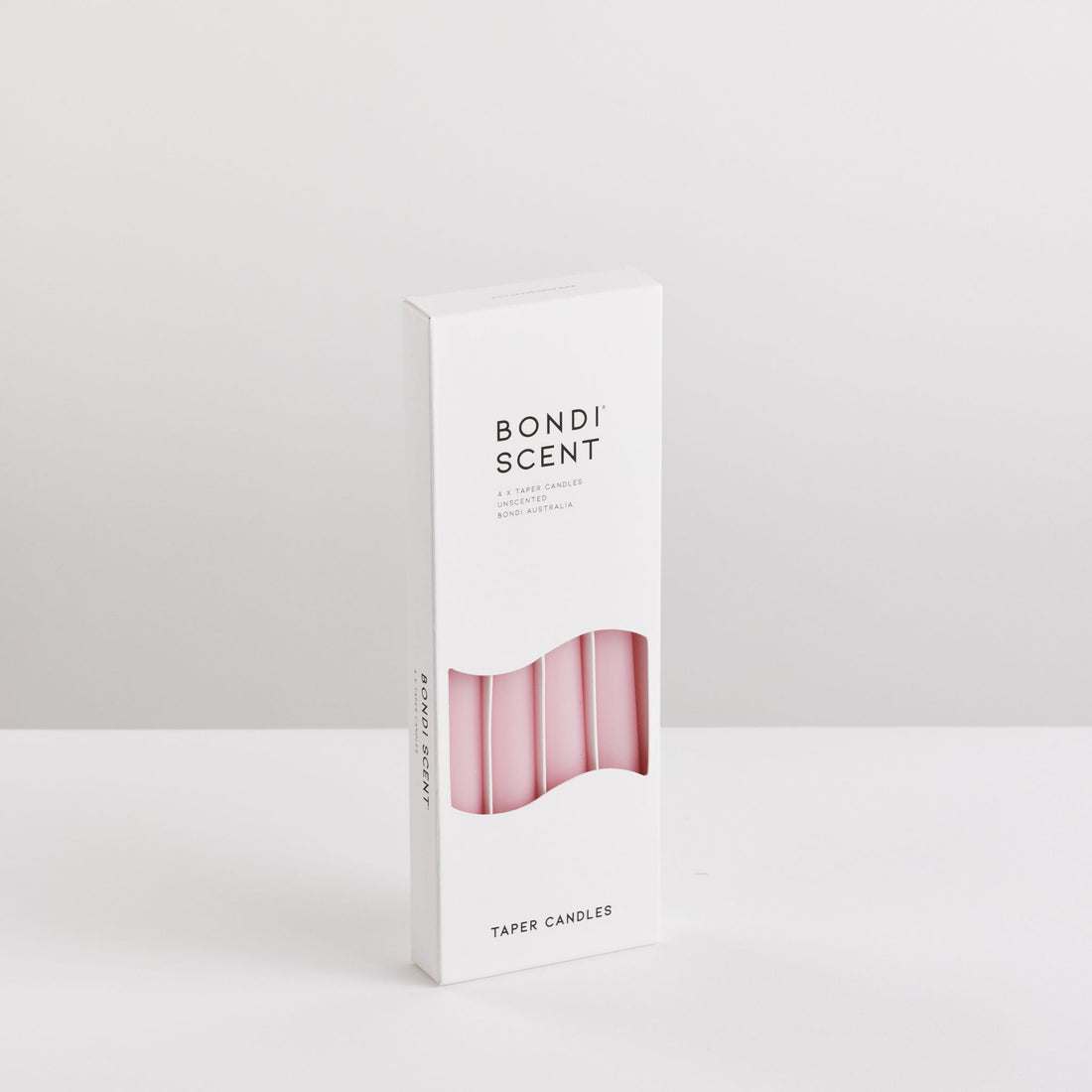 Bondi Scent pink taper dinner candles in packaging box on white background