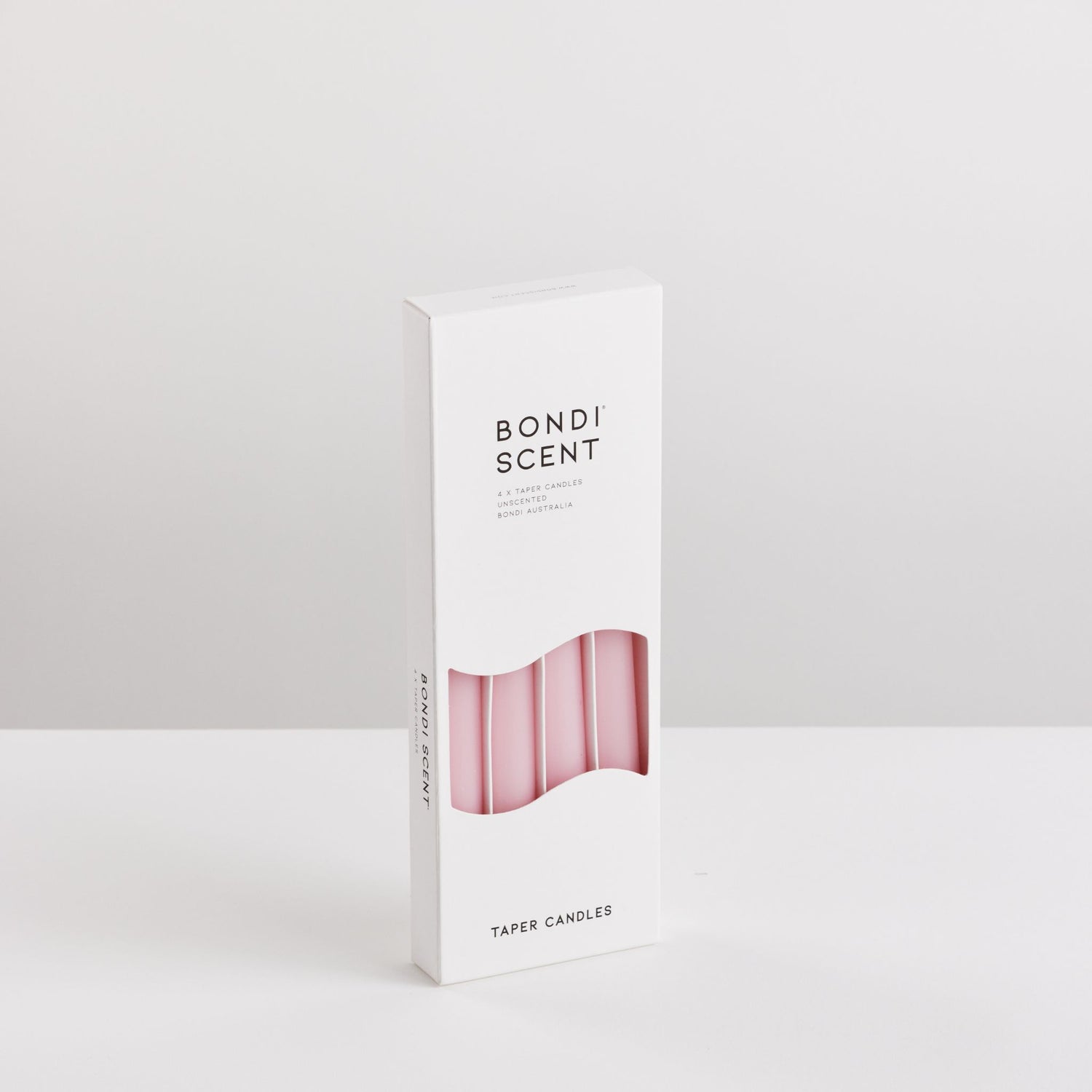 Bondi Scent pink taper dinner candles in packaging box on white background