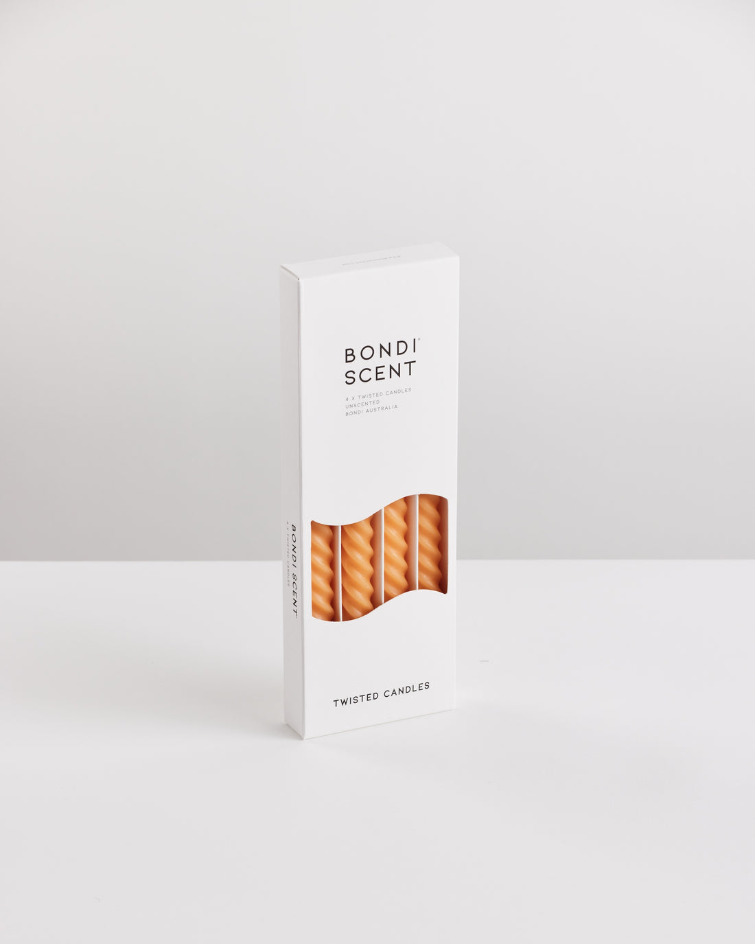 Bondi Scent orange twisted dinner candles in white packaging box on white background