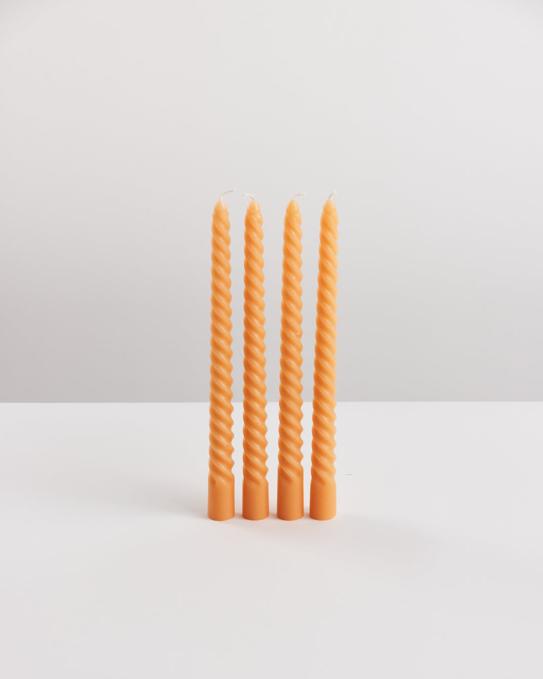 Bondi Scent orange twisted dinner candle bundle on white background