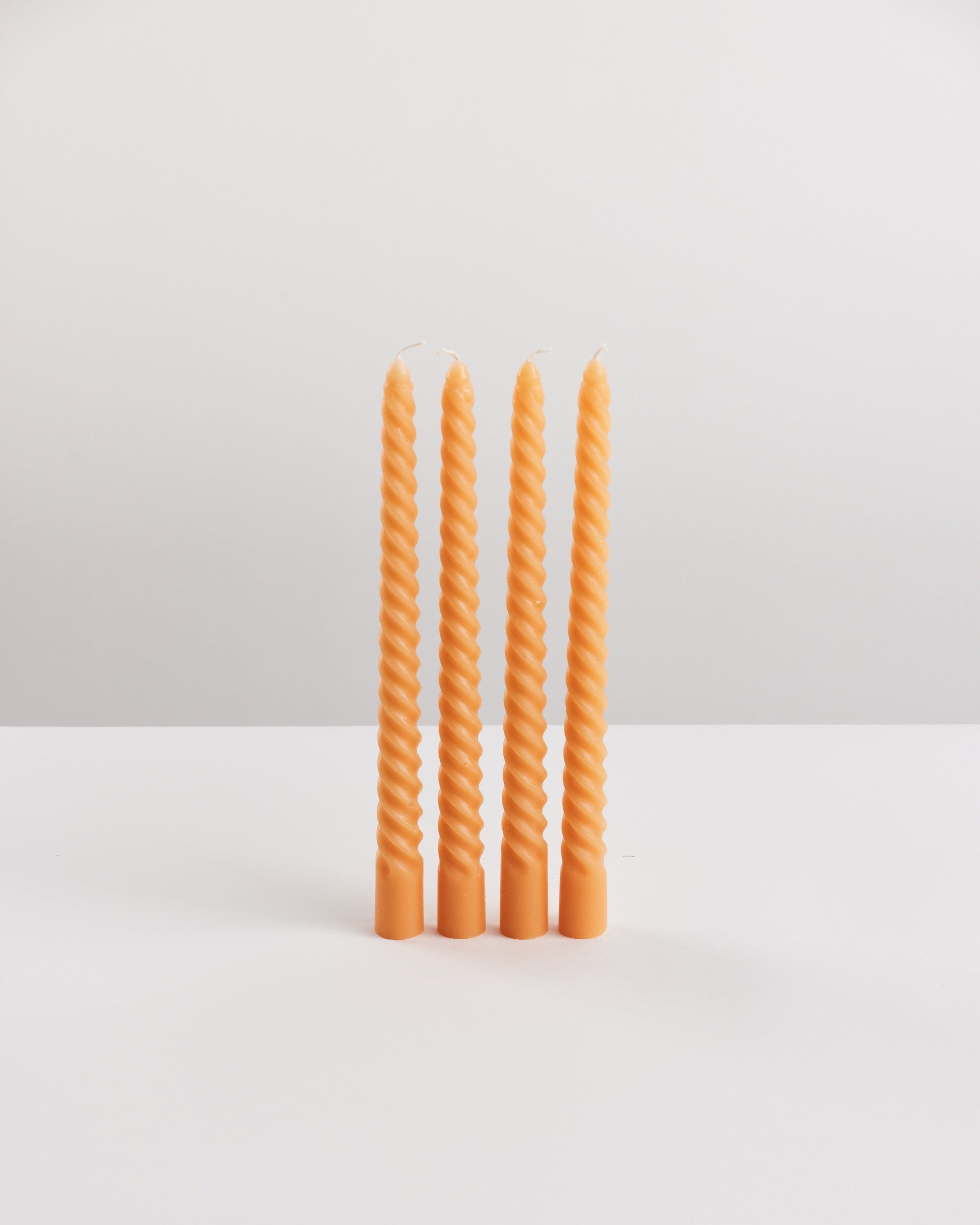 Bondi Scent orange twisted dinner candle bundle on white background
